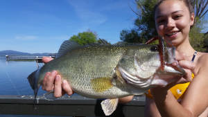 Angler holding a bass caught on Clear Lake